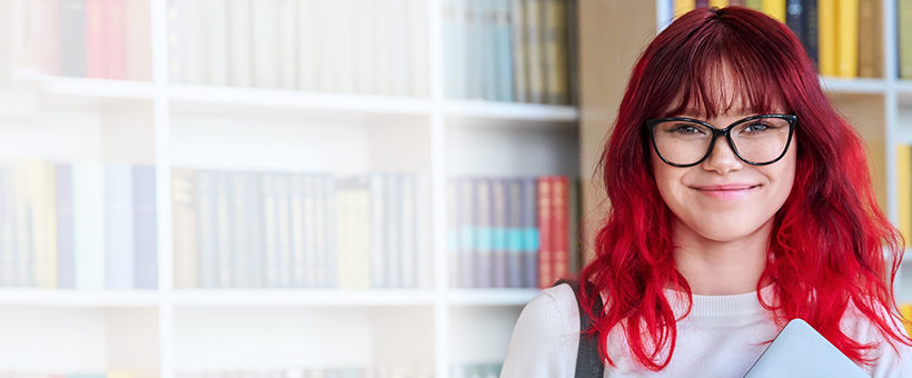 A woman smiling in a library